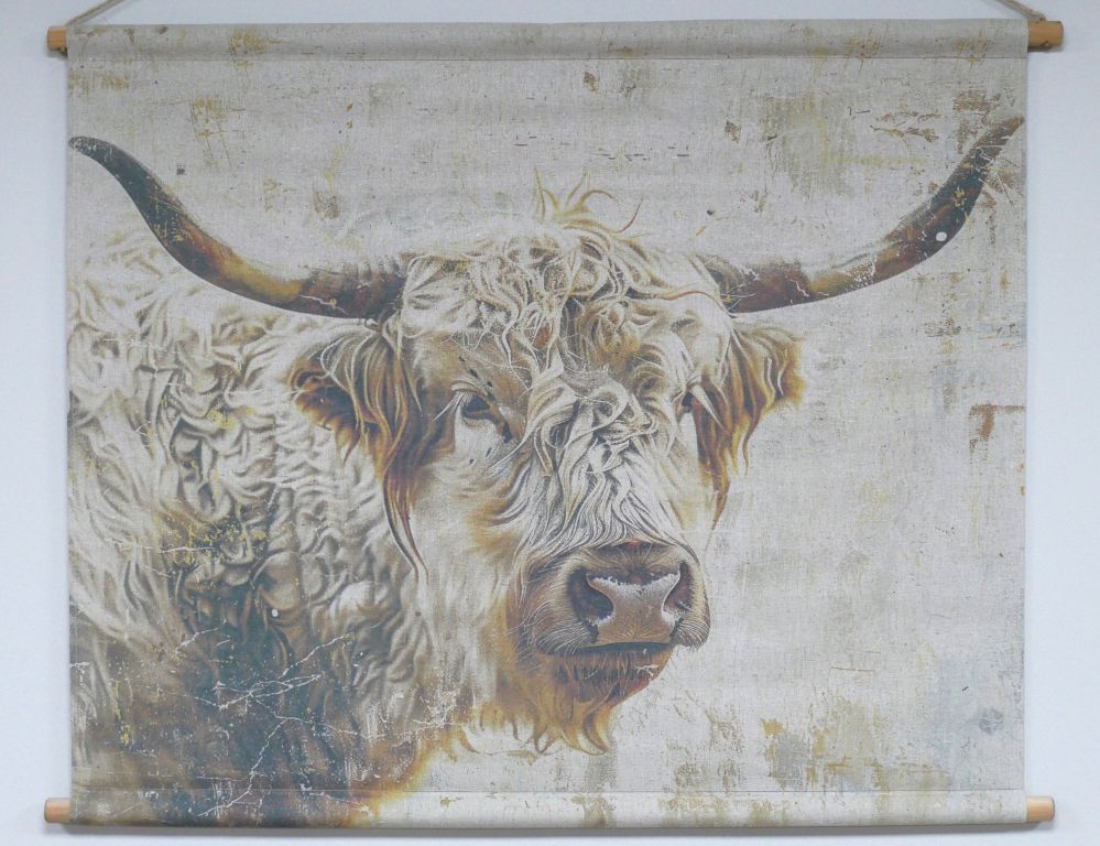 Fabric wall hanging showing a painted Highland cow with long curved horns and shaggy fur on a textured neutral background.