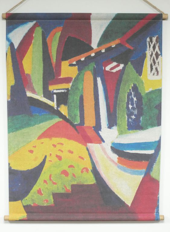 Fabric wall hanging showing a colourful abstract design with bold shapes and contrasting tones, printed on textured fabric.