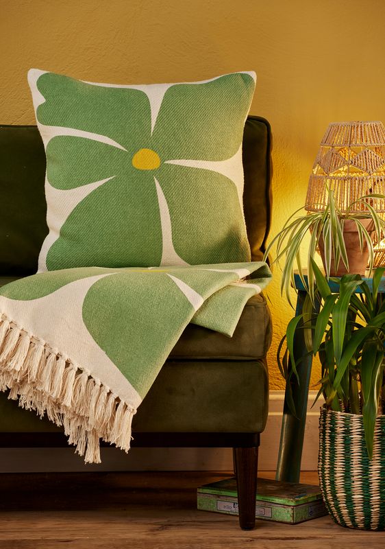 Sunshine Cushions with bold flower designs in orange, purple and green.