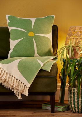 Sunshine Cushions with bold flower designs in orange, purple and green.