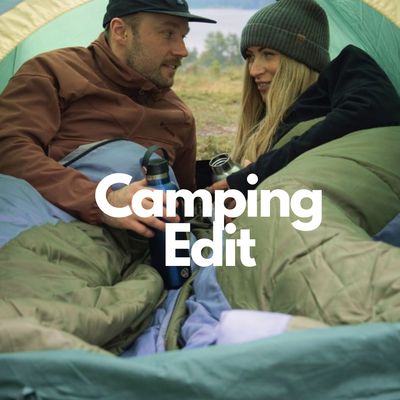  Camping Edit.  Two campers in sleeping bags with flask  of tea in tent.