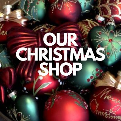 “Red, green and gold Christmas baubles with the words ‘Our Christmas Shop’.”