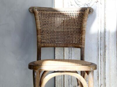 A close up view of the french wicker chair that we supply as a pair, showing the rattan work on the chair backrest.