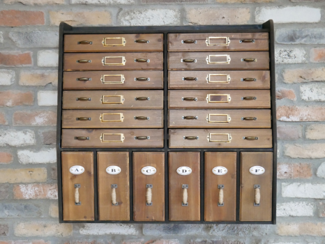 Twelve shallow drawers each with a metal name plate for identification.