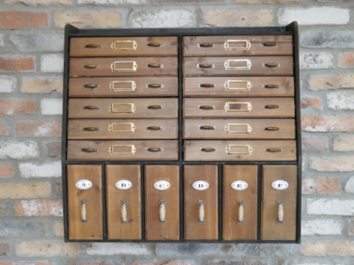 Twelve shallow drawers each with a metal name plate for identification.