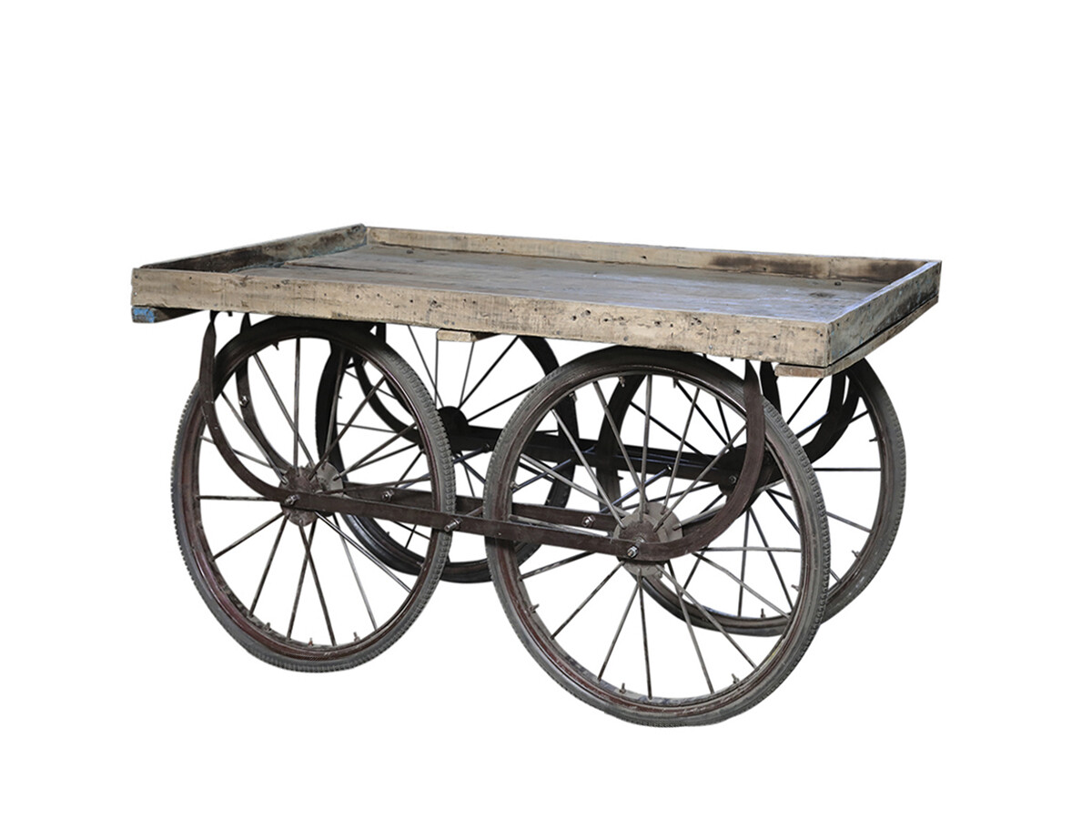 Vintage French cart with weathered wooden top and metal frame, featuring four iron-spoked wheels.