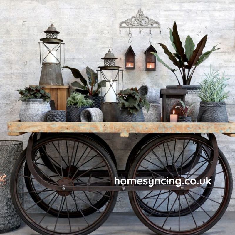 Vintage French cart with weathered wooden top and metal frame, featuring four iron-spoked wheels.