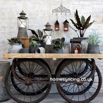 Vintage French cart with weathered wooden top and metal frame, featuring four iron-spoked wheels.