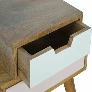Blush pink and white stacked bedside cabinet with two offset drawers, natural wood frame, and tapered wooden legs on a white 