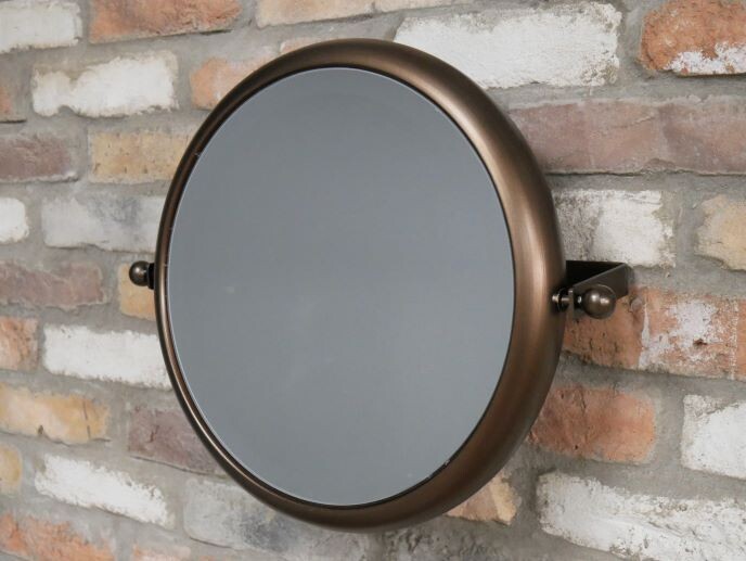 Round adjustable wall mirror with a smooth metal frame in an aged bronze finish, mounted on side brackets for tilt adjustment