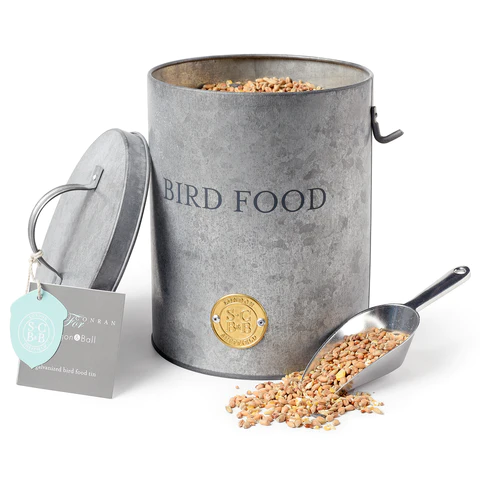 Sophie Conran Galvanized pot with a lid.  Metal Scoop with bird seed on the scoop and in tin.  Bird Food Motiff on front.