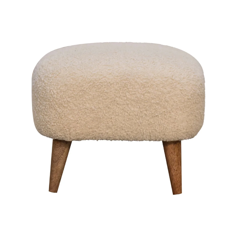 Soft boucle footstool with natural wooden legs, bringing comfort, texture and understated elegance to any living space.