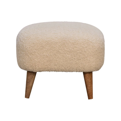Soft boucle footstool with natural wooden legs, bringing comfort, texture and understated elegance to any living space.