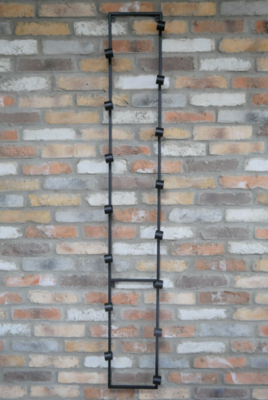 Edward wall-mounted metal wine rack holding bottles horizontally in a tall, space-saving design with an industrial finish.