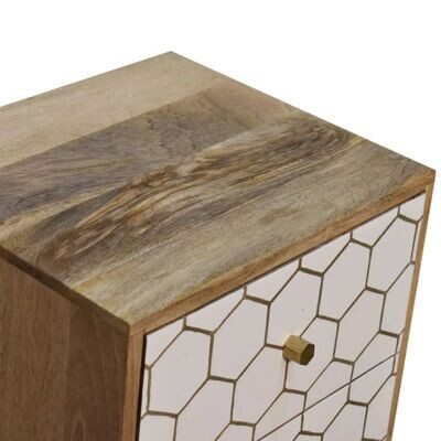 Amelia bedside cabinet in natural wood tones with white painted frame and carved geometric pattern on the door