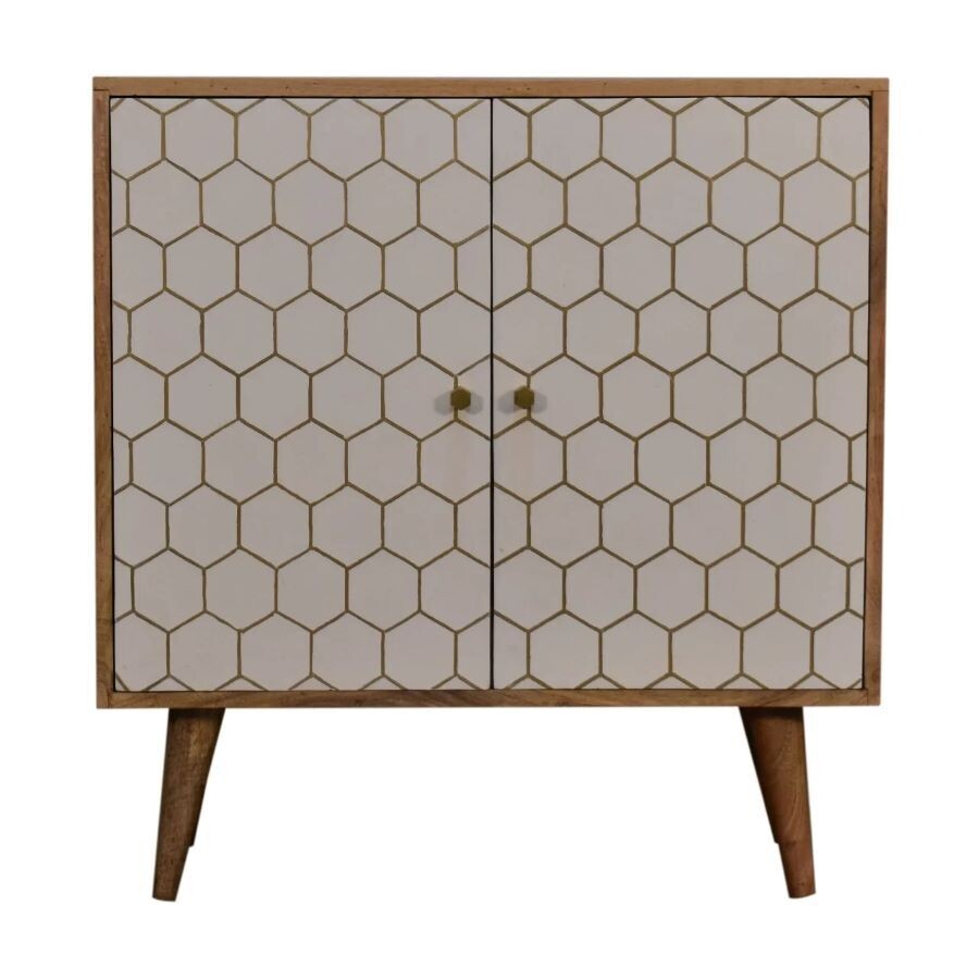 Wooden two-door cabinet with a white hexagonal patterned front, brass knobs, and tapered wooden legs.