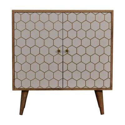 Amelia Cabinet Wooden two-door cabinet with a white hexagonal patterned front, brass knobs, and tapered wooden legs.