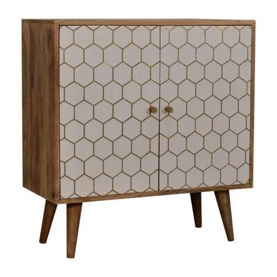 Wooden two-door cabinet with a white hexagonal patterned front, brass knobs, and tapered wooden legs.