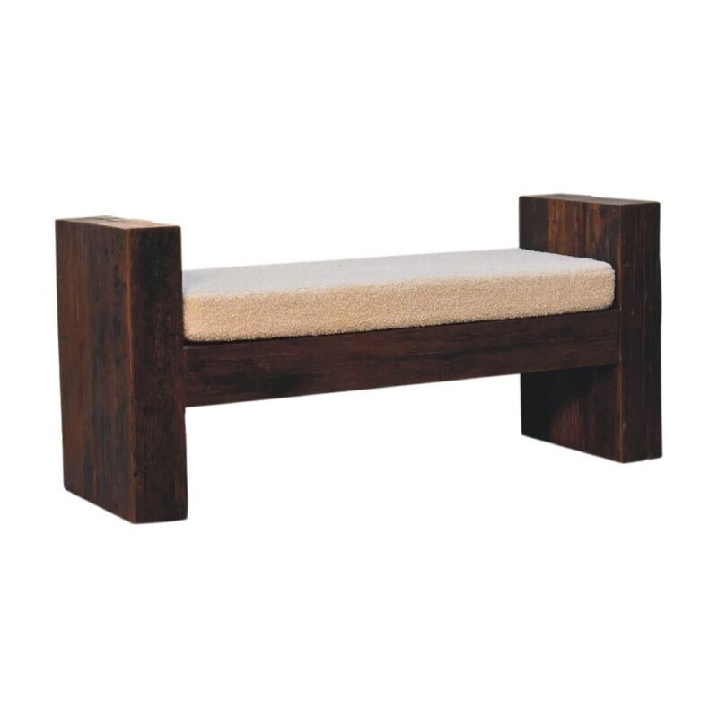 Dark wood bench with boucle cushion seat.
Bench at a slant view