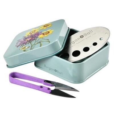 Asteraceae Design.  Light Duck Egg Blue with three yellow flowers and one purple flower design.
Square tin with purple handled snips