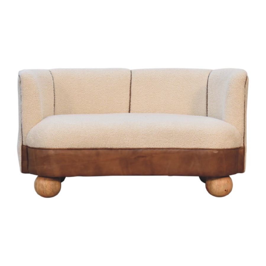 A hand crafted sofa built with solid mango wood, and finished with an oak colouring. The fabrics used are boucle cotton and leather which combine to produce a very alluring and comfortable sofa.
Width 132 cm and depth 62 cm.  