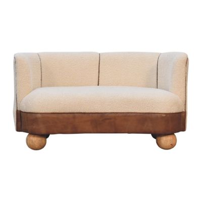 Boucle Cream Leather Small Sofa A hand crafted sofa built with solid mango wood, and finished with an oak colouring. The fabrics used are boucle cotton and leather which combine to produce a very alluring and comfortable sofa.
Width 132 cm and depth 62 cm.