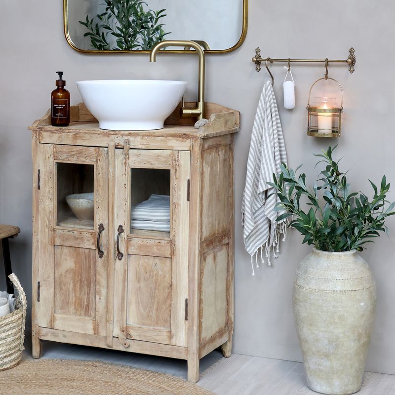 small display unit is an extremely useful and attractive cabinet made from recycled wood, with two glass panels on each of the two opening doors. Shown here in a room setting.
Height 100 cm x 74 cm x 36 cm