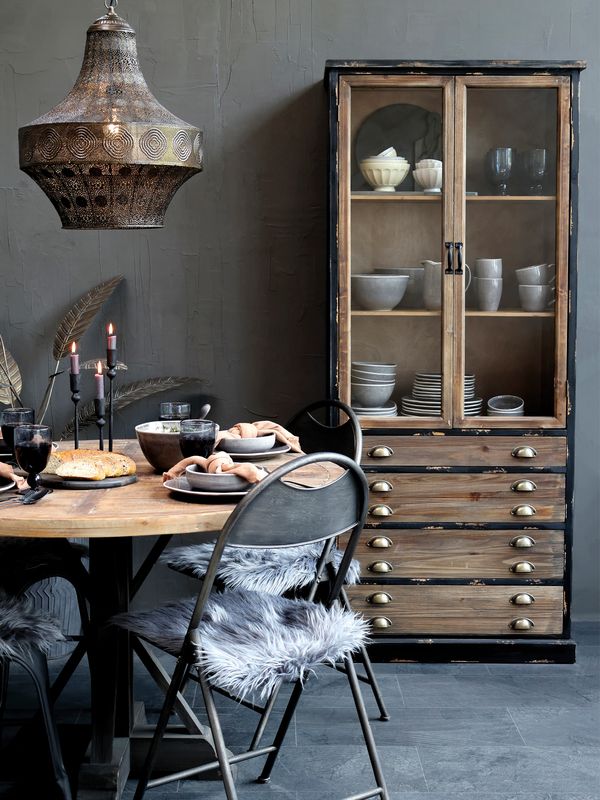 Tall Wall Unit.  Antique Black Finish with 4 wide drawers finished in recycled repurposed wood and upper two door display door cabinet with two shelves.
Lifestyle Image:  set in room scene with circular table and bistro chairs