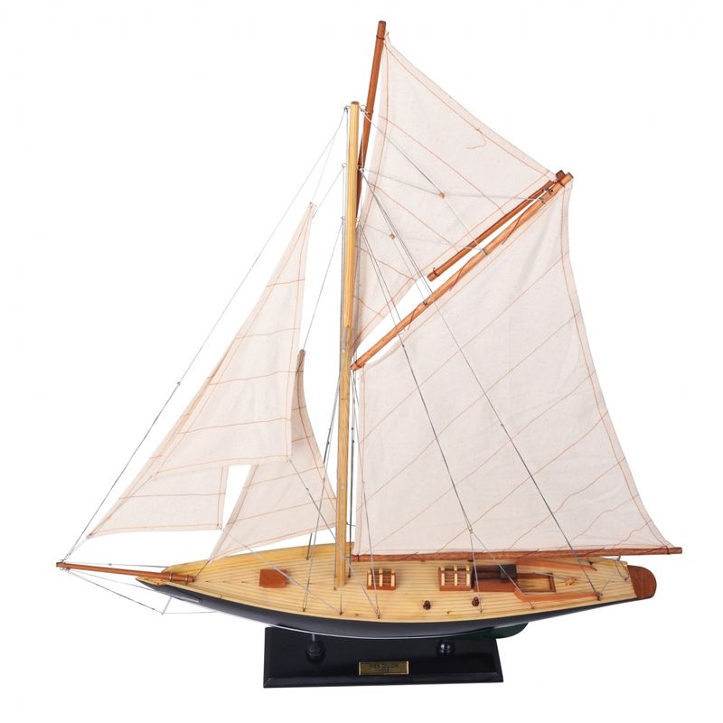 A lovely dark green hull and the yacht sitting on a wooden stand.