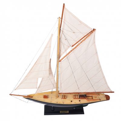 A lovely dark green hull and the yacht sitting on a wooden stand.