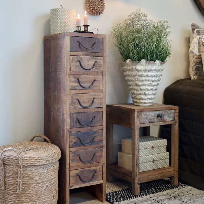Tall rustic wooden chest of drawers with eight drawers, curved metal handles and a weathered natural timber finish.