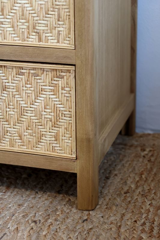 Rattan bedside table with two drawers, woven fronts, natural finish, wooden knobs and compact design.