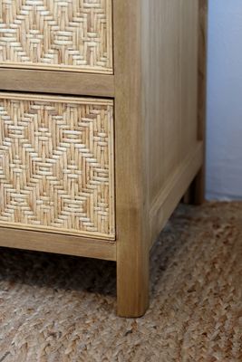 Rattan bedside table with two drawers, woven fronts, natural finish, wooden knobs and compact design.