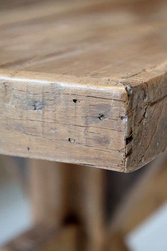 Recycled wood bench with a simple, sturdy design, featuring natural grain and warm tones for versatile seating and display.
