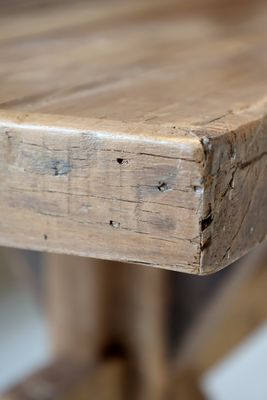 Recycled wood bench with a simple, sturdy design, featuring natural grain and warm tones for versatile seating and display.