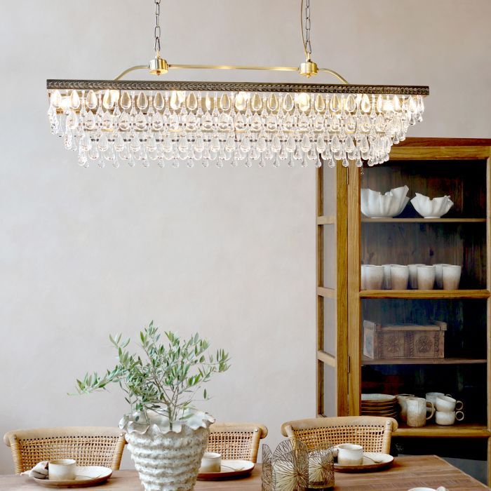 Multi-tier chandelier with cascading clear glass prisms in a classic Versailles-inspired design.