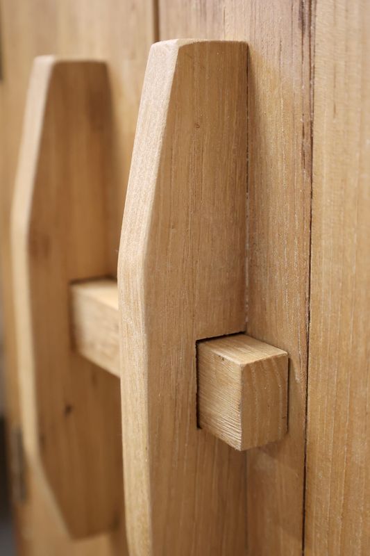 Natural oak bedside cabinet with double doors, compact storage and timeless craftsmanship for calm, uncluttered living.