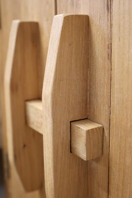 Natural oak bedside cabinet with double doors, compact storage and timeless craftsmanship for calm, uncluttered living.