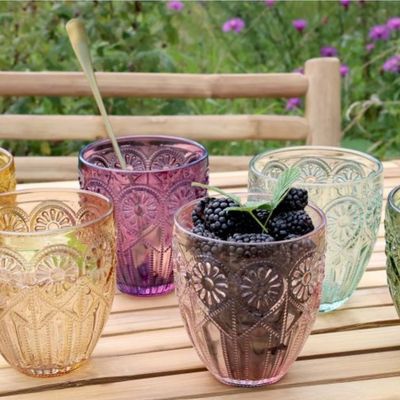Six embossed  Fleur Design glass tumblers in green, pink, amber, clear, yellow, and blush