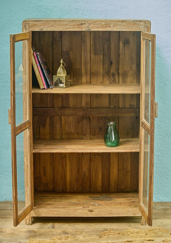 Wooden display cabinet with double glass doors and internal shelves, finished in a natural, lightly weathered wood tone.
