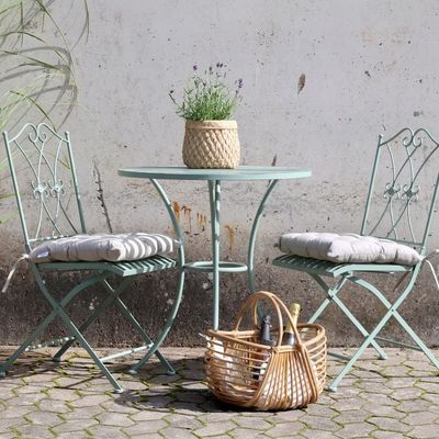 Florence Bistro Set in Antique Verte with a round slatted table and two folding chairs featuring decorative backrests
