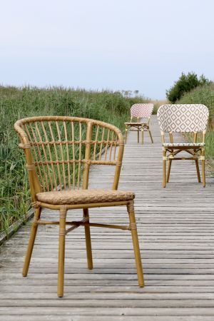 Braided rattan bistro Chairs with curved backs and woven seats.