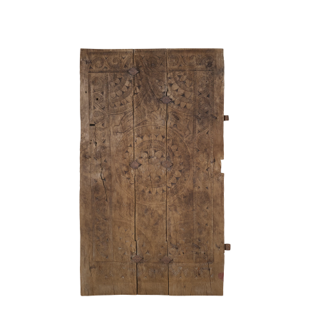 Antique Indian village door with intricate hand-carved patterns, weathered wood and aged patina.