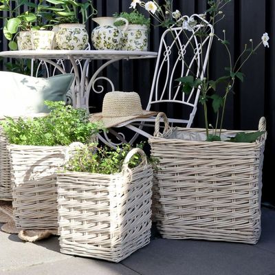 Set of three square woven willow baskets with carry handles and waterproof lining, suitable for storage, laundry or plant pot