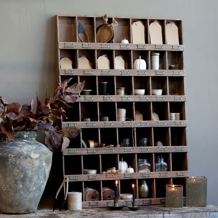 Rustic wooden pigeonhole cabinet with labelled compartments, styled with ceramics, twine, candles
For example, “Dark-brown