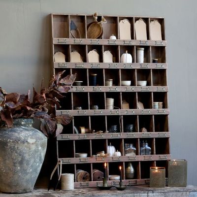 Rustic wooden pigeonhole cabinet with labelled compartments, styled with ceramics, twine, candles
For example, “Dark-brown