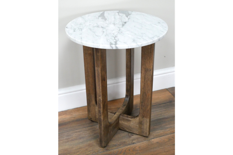 Round marble top side table with sculptural wooden base, tall and slender with warm wood tones and a simple, elegant form