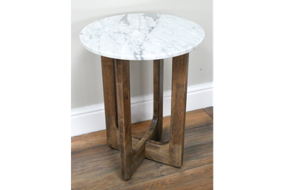 Round marble top side table with sculptural wooden base, tall and slender with warm wood tones and a simple, elegant form
