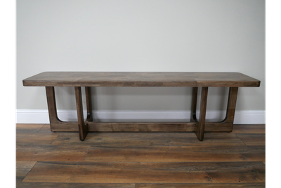 Wooden bench with a warm finish, rounded edges and open-frame legs with a low stretcher, simple and sturdy in design