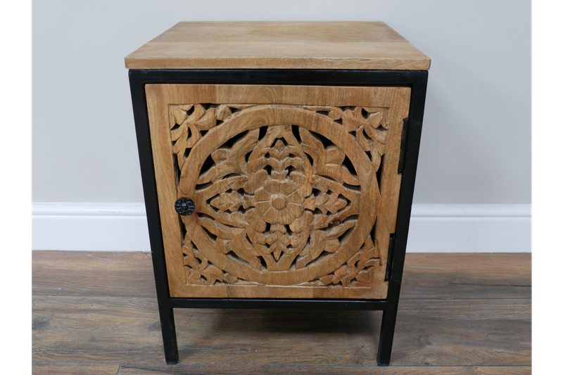 Hand-carved wooden bedside cabinet with floral door design, natural wood finish and black frame.